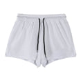 Men's white and black quick-drying nylon sports shorts on a size chart background.