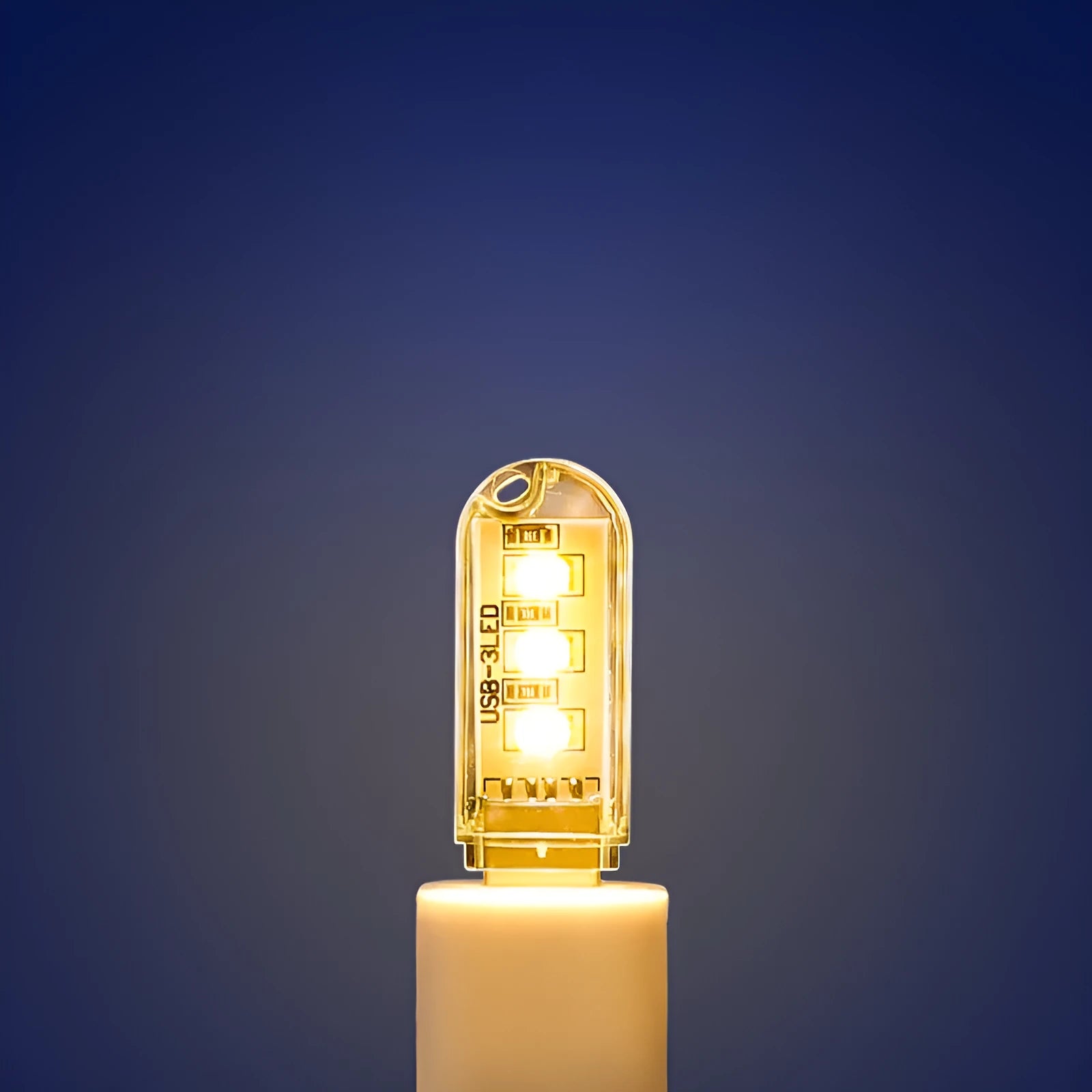 Small white USB-powered baby night light showing warm and white light options on a table