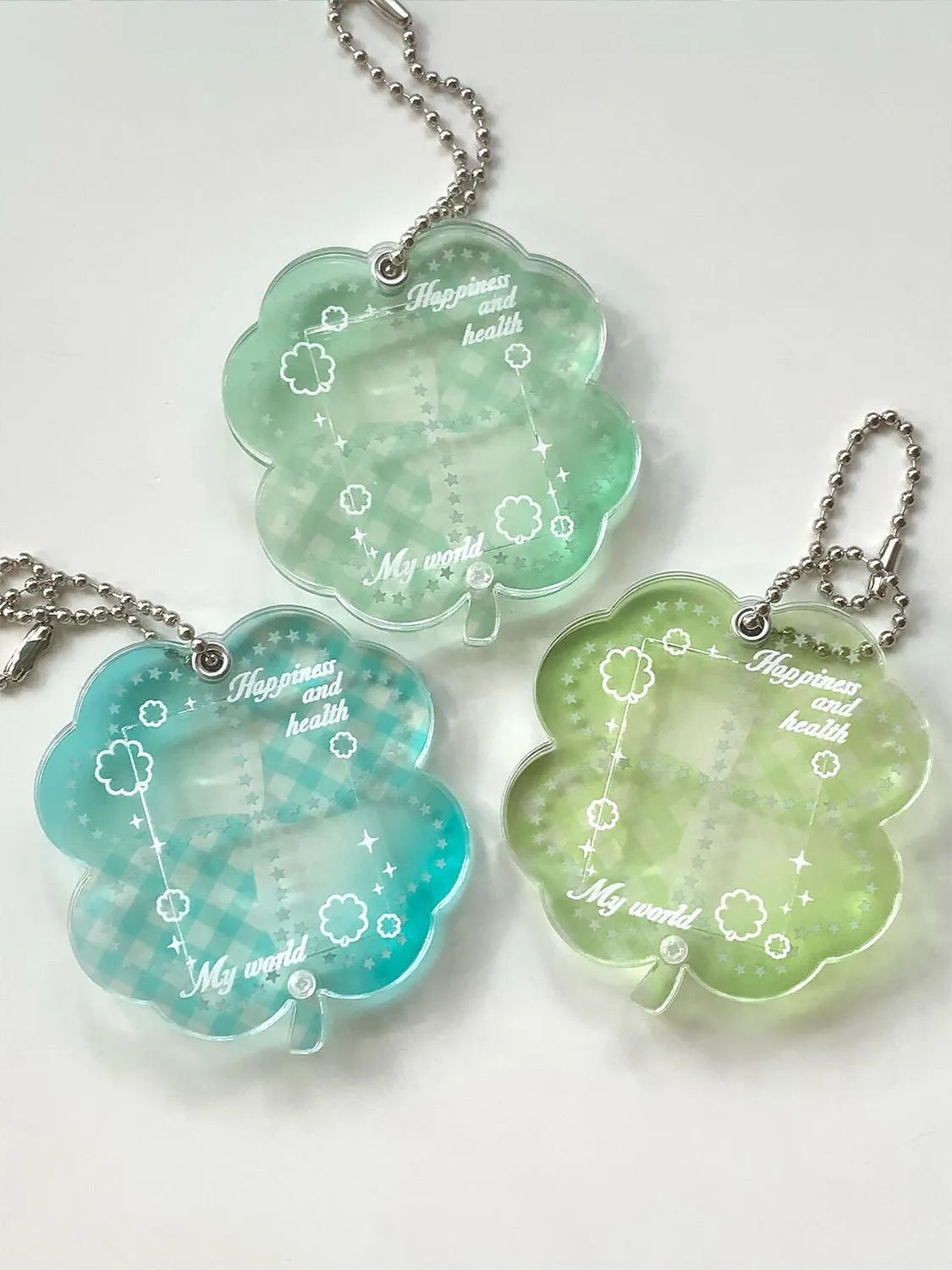 Acrylic four-leaf clover pendant keychain in blue, grass green, or mint green.
