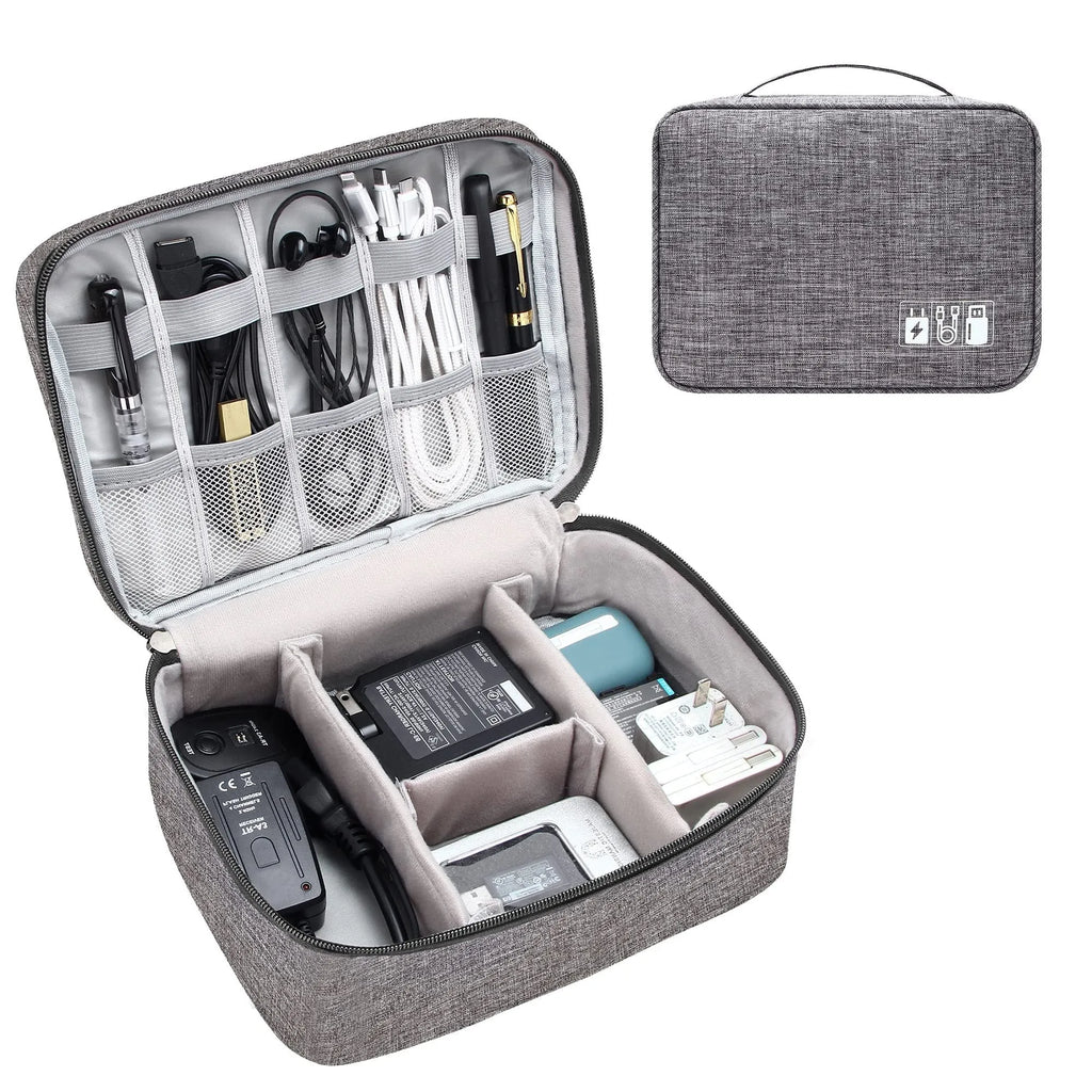 Black travel cable organiser bag open, showing mesh pockets, elastic loops, and removable padded dividers inside.
