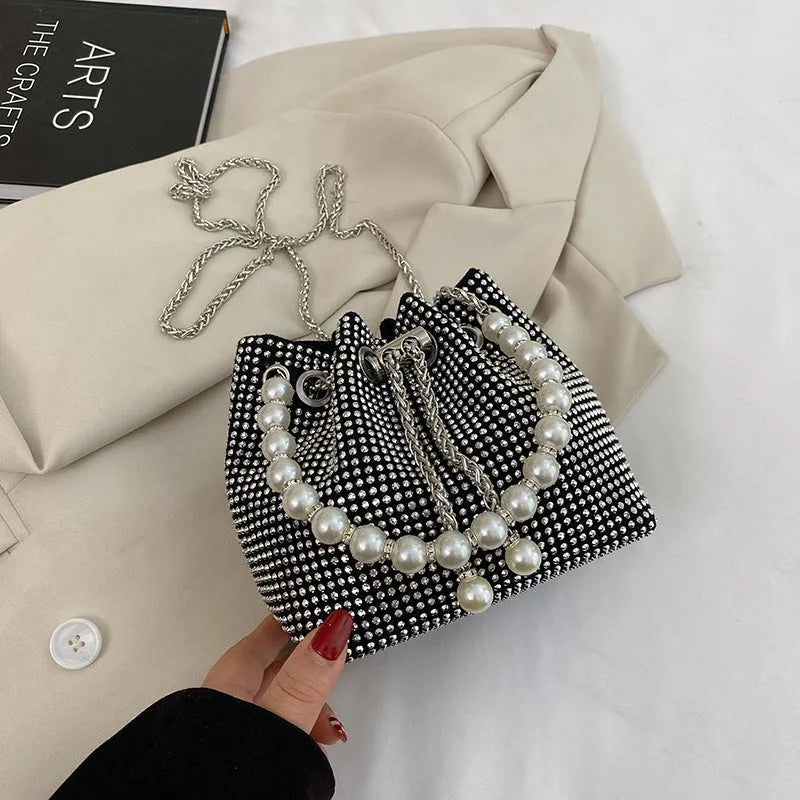 Diamond pattern women's crossbody bag in PU leather with metal chain strap, showing internal phone pocket and change purse.