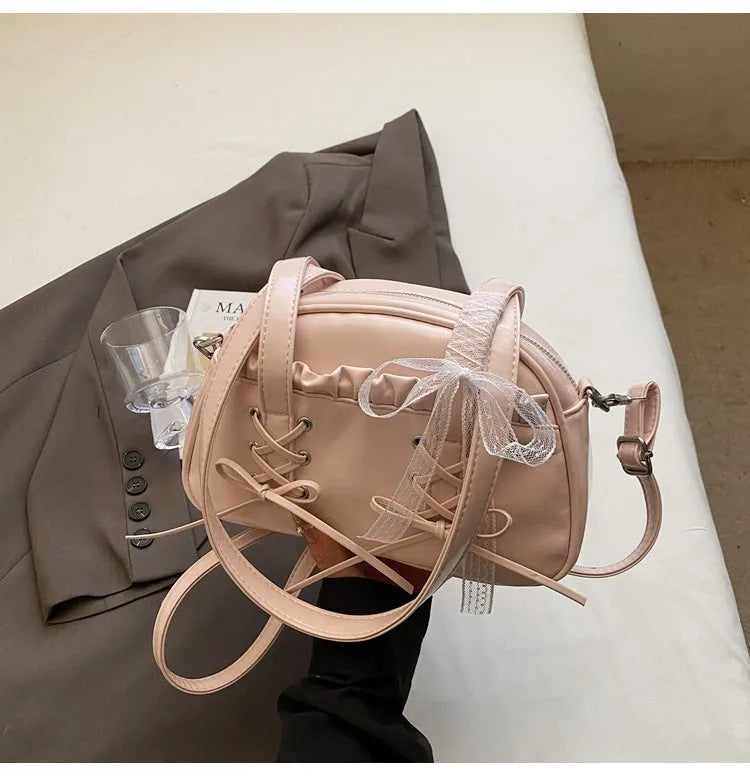 Women's casual bandage bow handbag in PU with shoulder strap and sewing thread detailing.