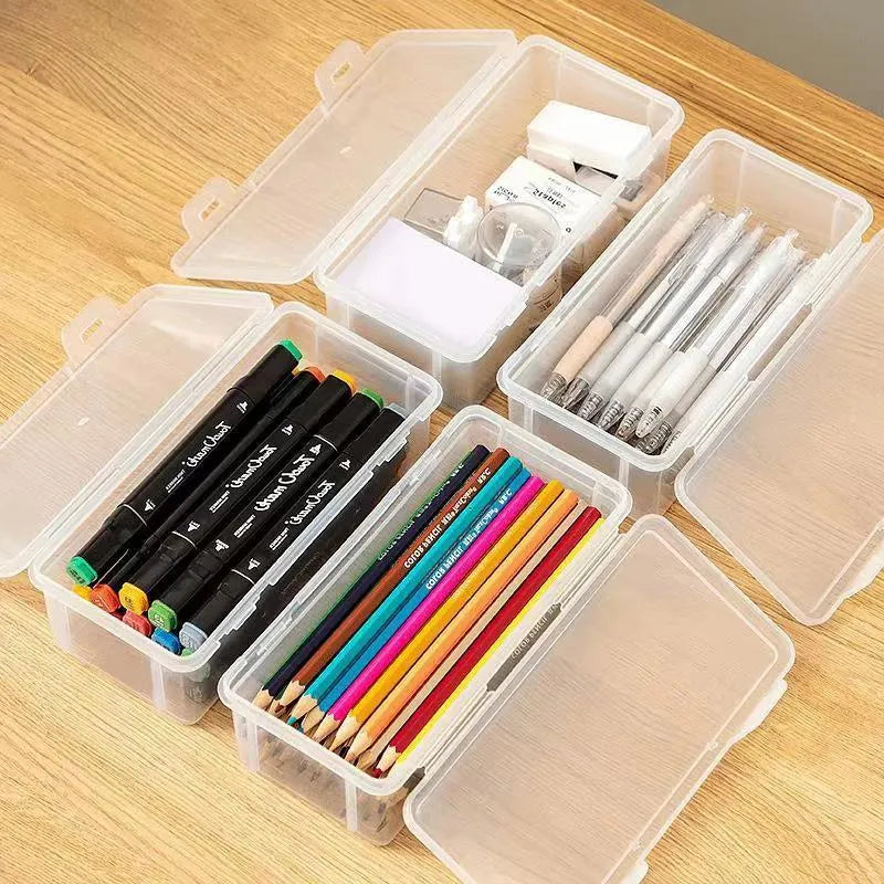 Transparent plastic stationery storage box containing pencils and colour crayons