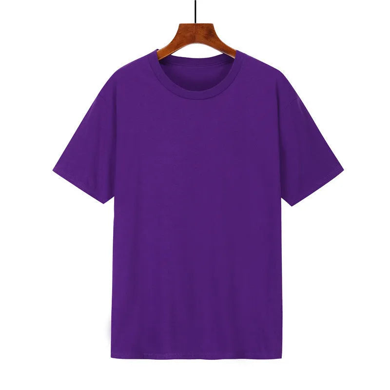 Man wearing a black loose-fit cotton T-shirt with short sleeves, showcasing casual style.