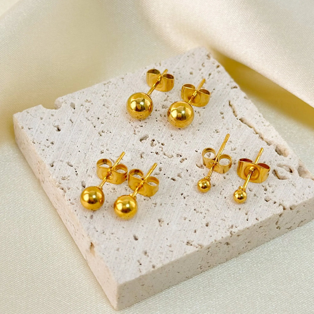 Stainless steel ball stud earrings in gold and silver finishes, showing 3mm to 6mm size comparison