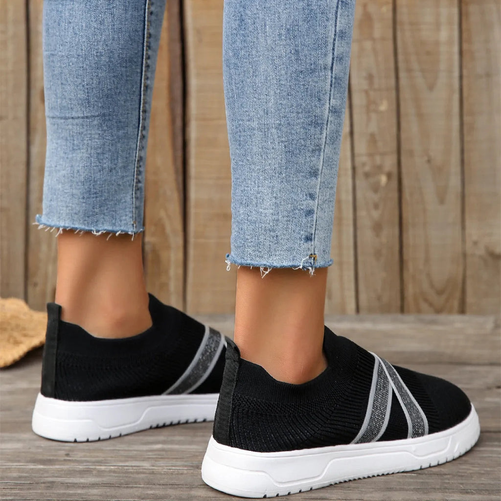 Black women's flat mesh shoes with flyknit fabric upper and tassel detail