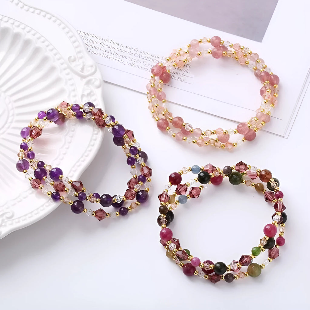 Colourful three-ring crystal bracelet with tourmaline, strawberry quartz, and amethyst beads on an adjustable cord.