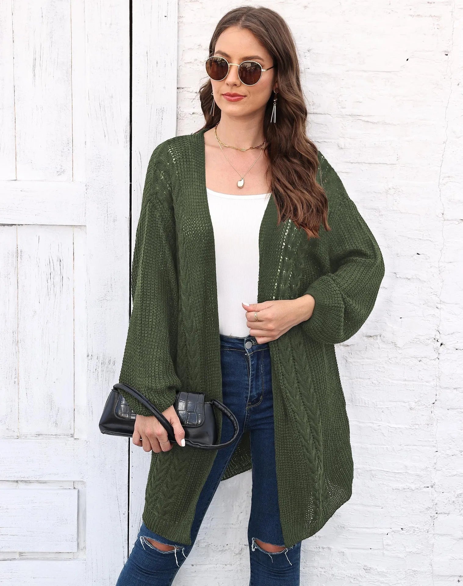 Women's loose acrylic sweater coat in solid colour on hanger