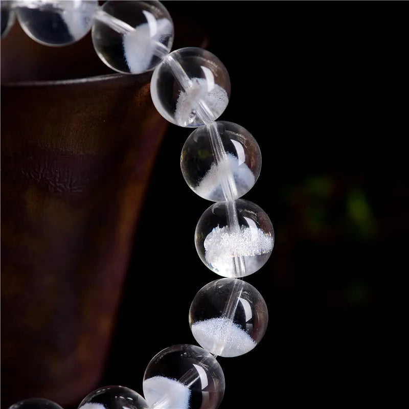 Women's white crystal ghost pyramid bracelet with ruyi symbol on wrist, showing adjustable bead sizes.