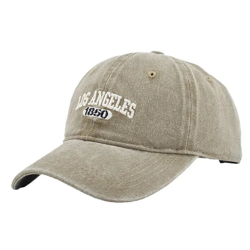 Retro personalised distressed embroidered peaked cap in beige colour with adjustable strap and conical crown.