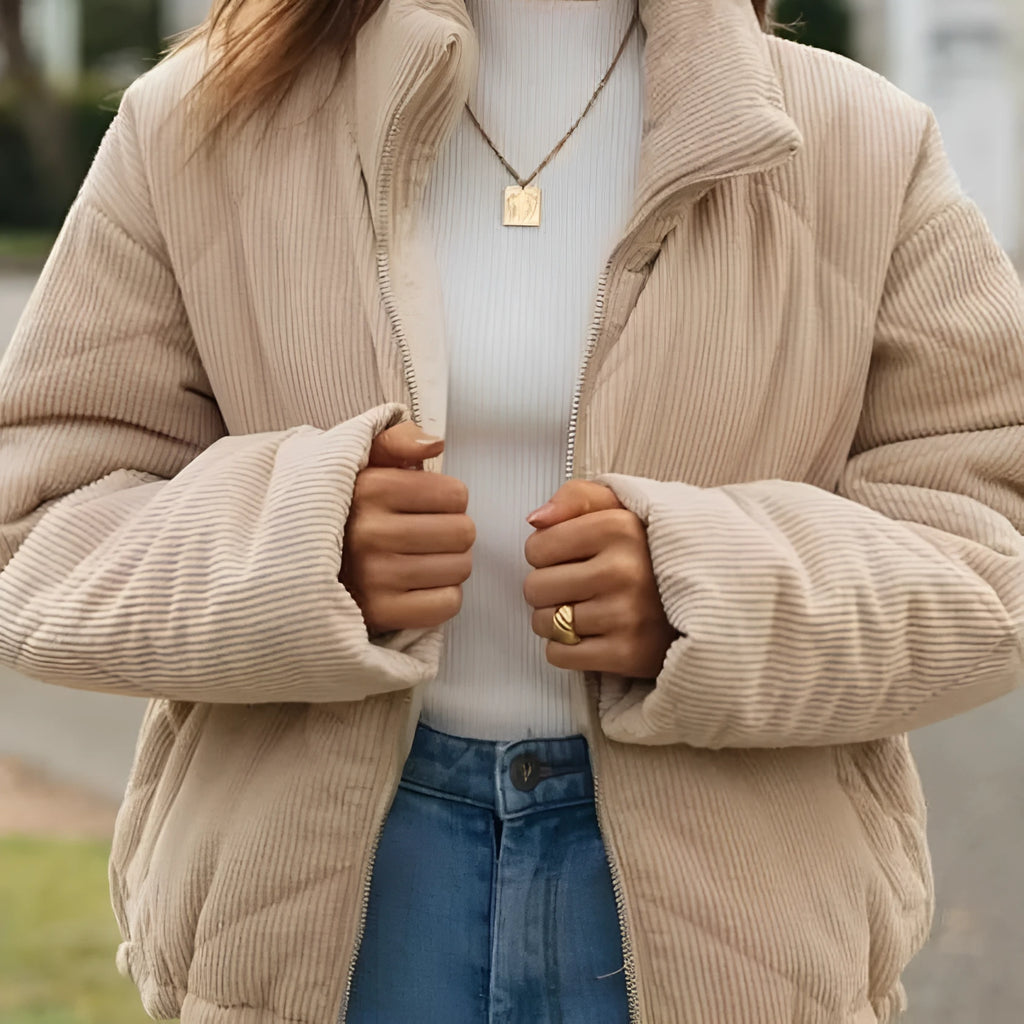 Apricot coloured women's corduroy jacket with stand collar and front zip, showing textured fabric detail