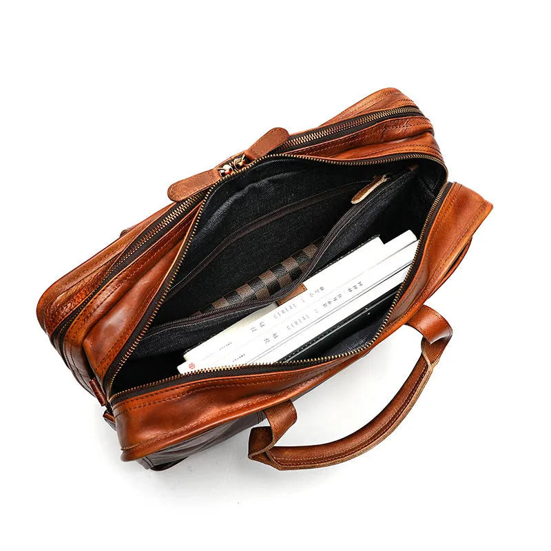 Brown vintage leather men's briefcase showing internal laptop and document pockets