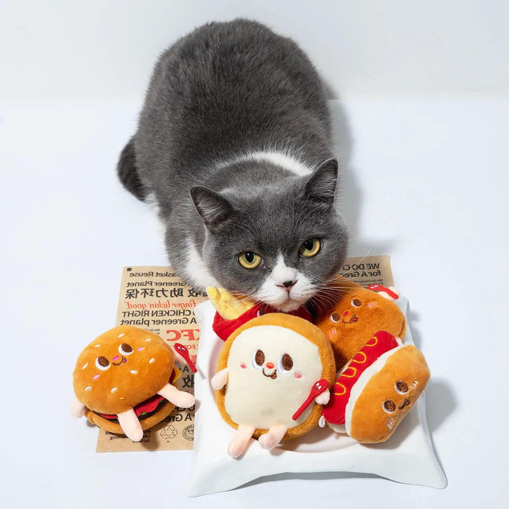 Set of five soft cat toys shaped like hamburger, chicken leg, fries, bread, and hot dog on a white background