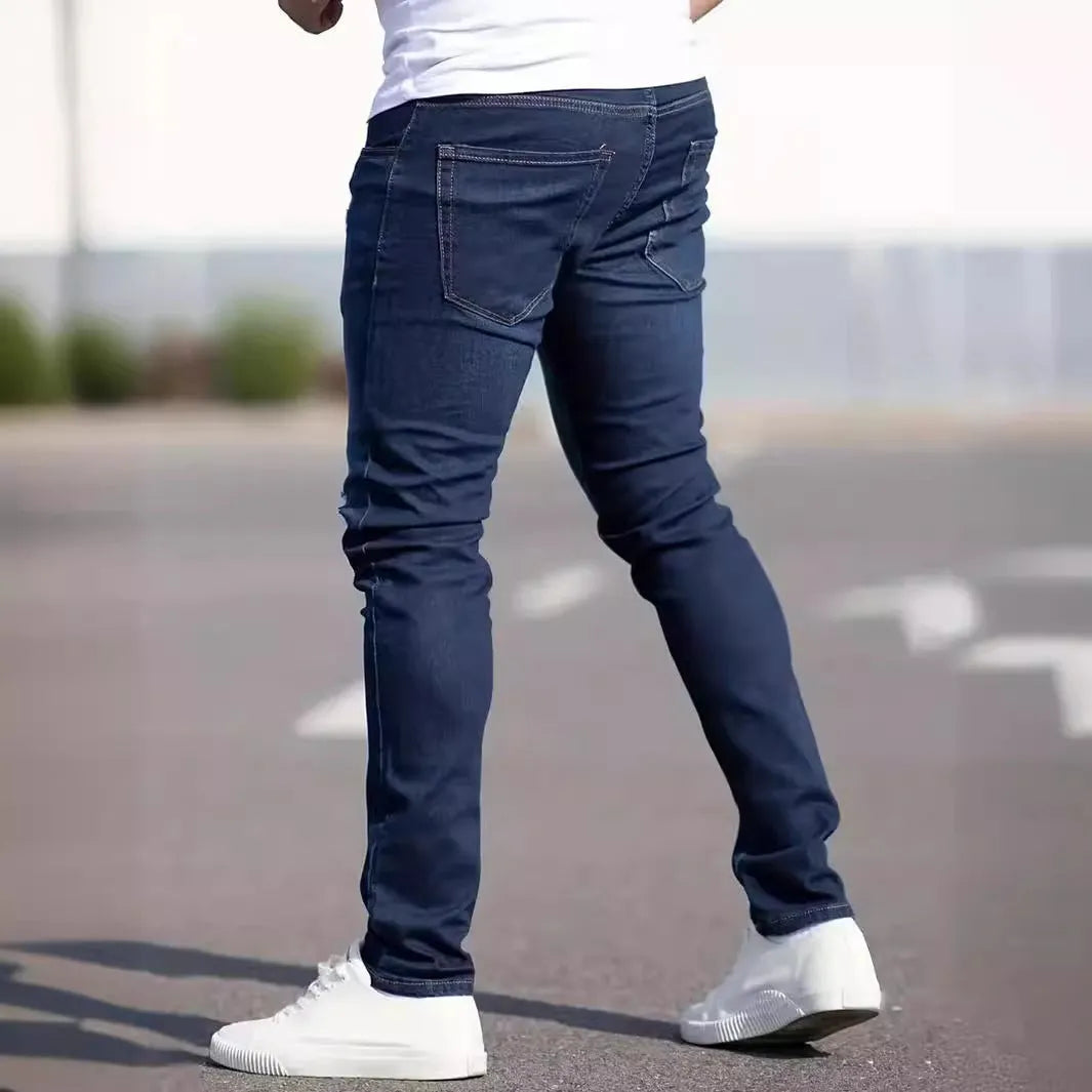 Men's dark blue slim fit casual jeans with mid waist and zipper fly opening