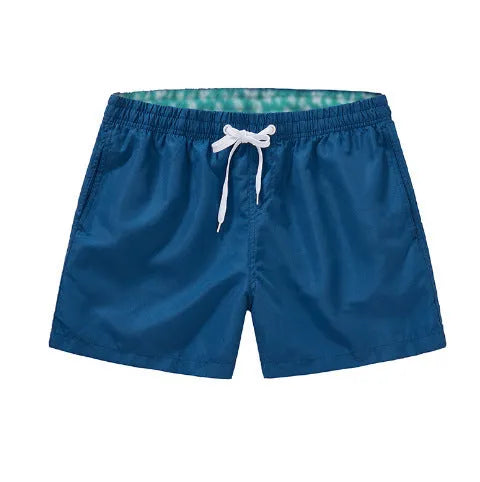 Men's straight-leg beach shorts in polyester, shown in a colour from the range including fluorescent yellow, black, or navy.