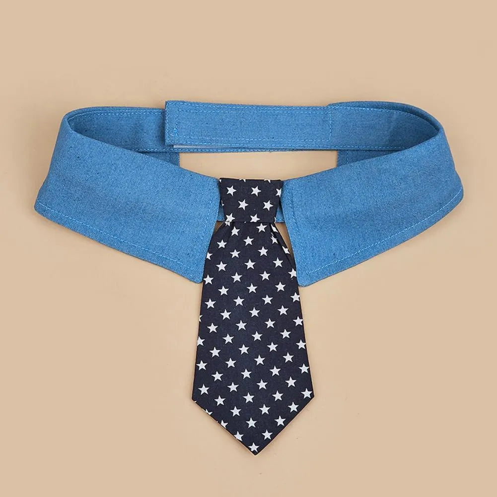 Blue denim dog collar styled as a necktie with white star pattern, showing fastener tape adjustment.