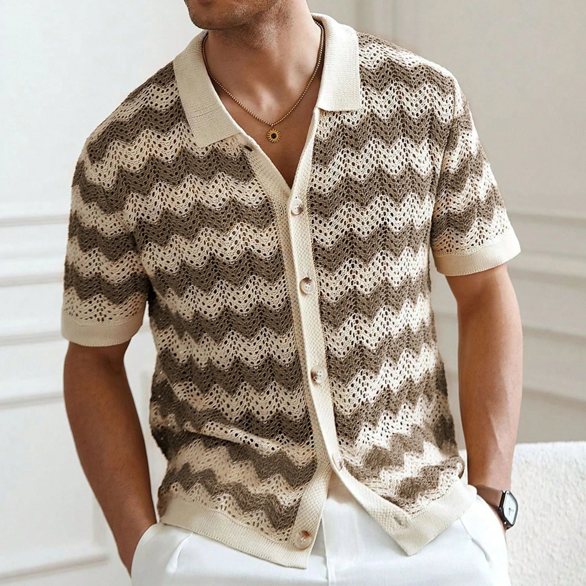 Short-sleeved blue corrugated knit sweater with a hollow jacquard texture on a hanger.