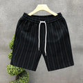 Men's black and white striped fleece-lined casual shorts with an ankle-banded cuff on a hanger.