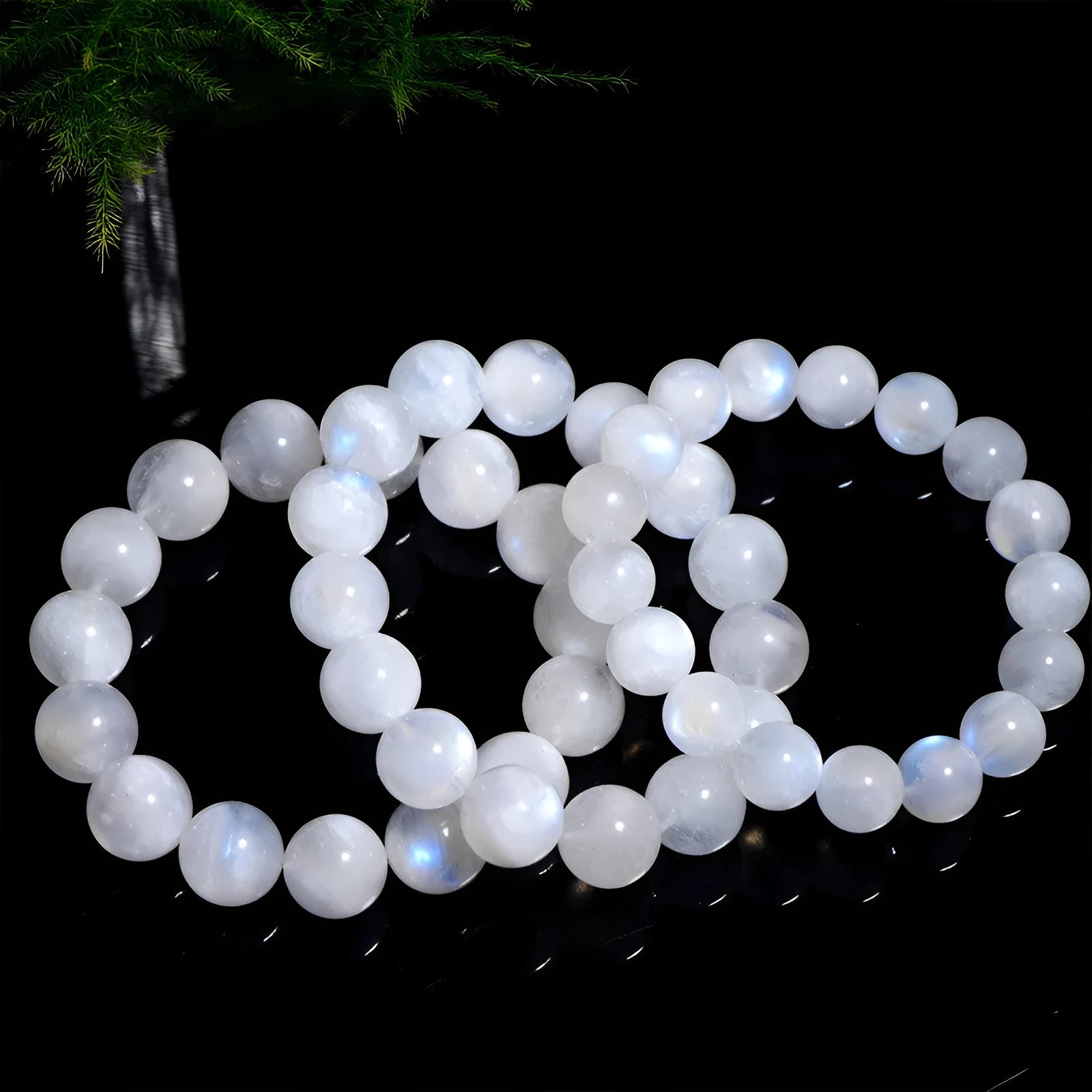 Natural blue moonstone bracelet with polished round beads showing sizing from 5mm to 12mm diameter