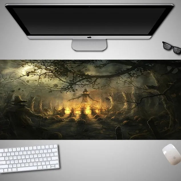 Oversized black Halloween-themed mouse pad with spooky artwork on a desk next to a gaming mouse.