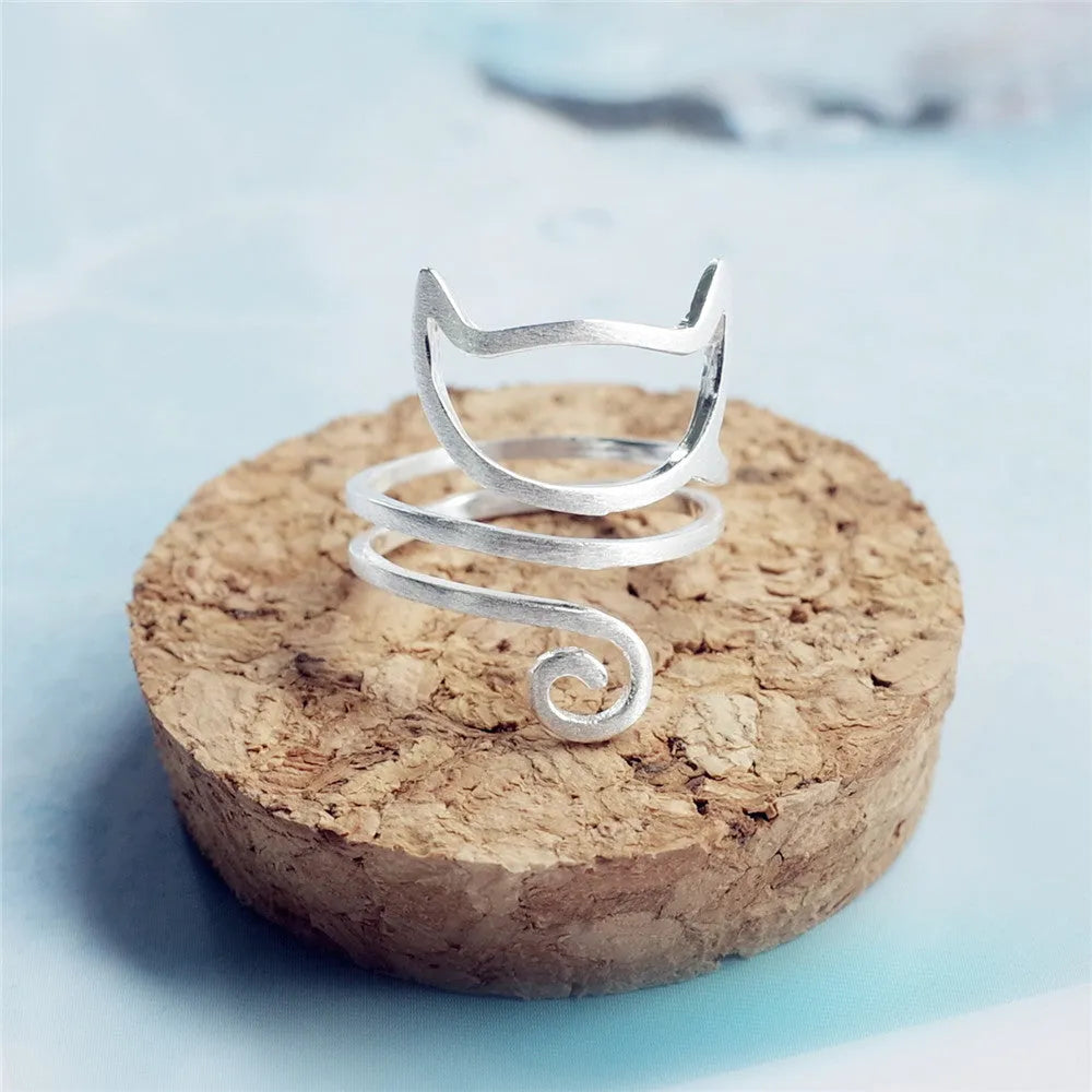 S925 silver adjustable cat ring with brushed winding design on a neutral background