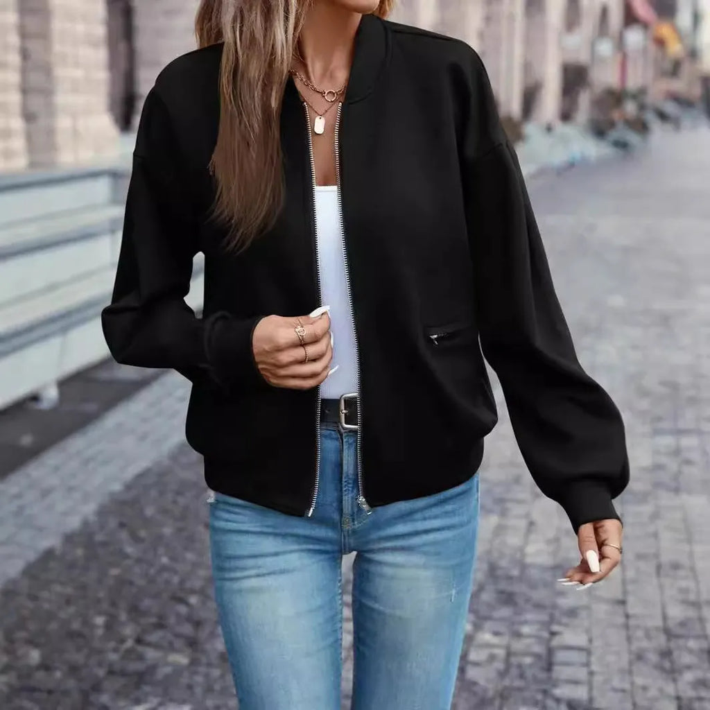 Women's solid black long sleeve zip jacket on a hanger, front view.