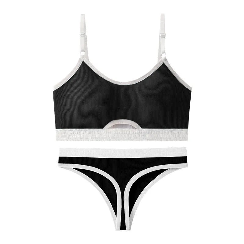 Women's contrast back sports bra vest and briefs set in black with underwire and padding.