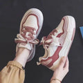 Women's beige and pink low-top rubber sneakers with height-increasing sole on a white background