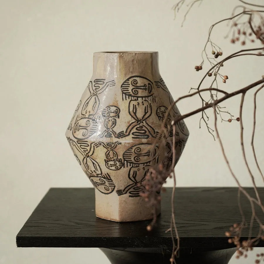 Hand-painted ceramic cylindrical vase with tribal totem patterns in vintage carved style