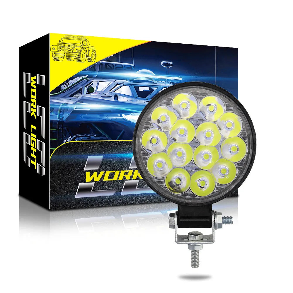 White LED mini round auxiliary work light with aluminium housing for vehicle mounting.
