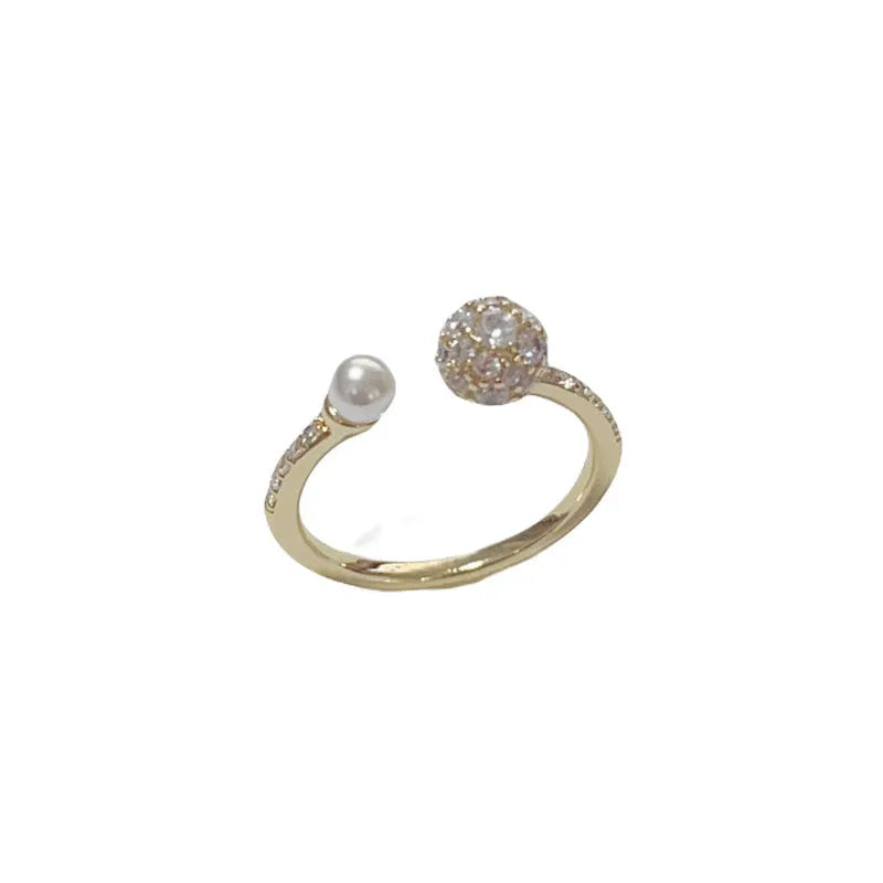 Adjustable open-end pearl ring with round zircon stone in gold or silver finish