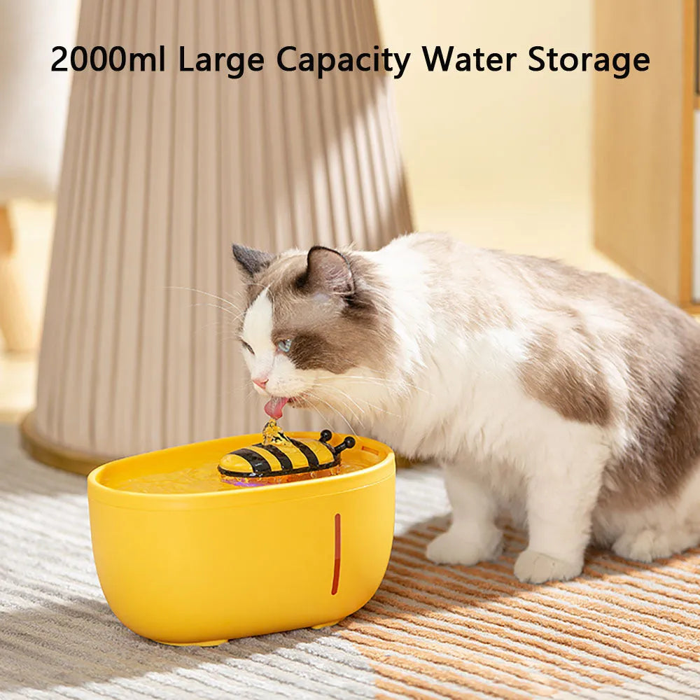 Yellow automatic cat water fountain with filter and USB cable on anti-slip base.
