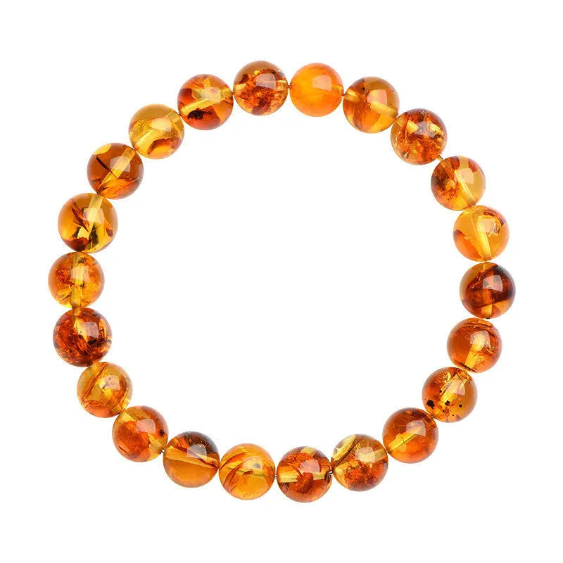 Natural yellow piebald amber bracelet with geometric beads on wrist