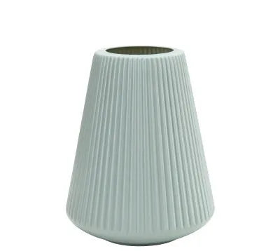 Simple plastic decorative flower vase in blue, green, pink, or white on a desktop.