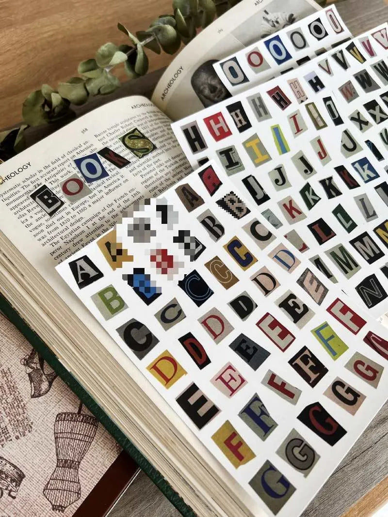 Set of printed cute style decoration stickers showing English letters, numbers, and weekly words on sheets.
