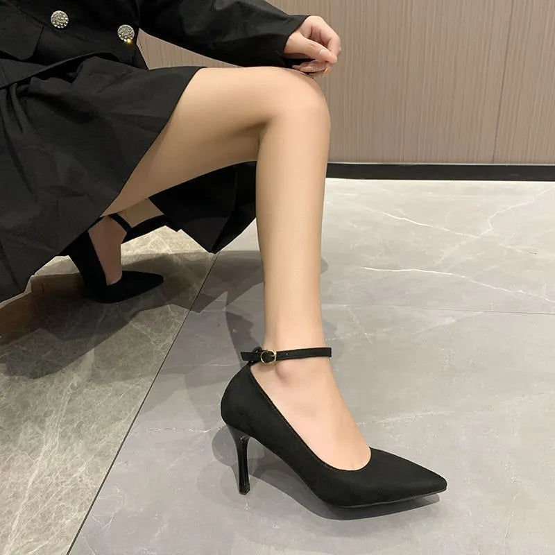 Women's black stiletto heel pumps with skull pattern and buckle closure