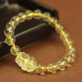 Yellow leather bracelet with an artificial citrine crystal Pi Xiu charm in Chinese national style.