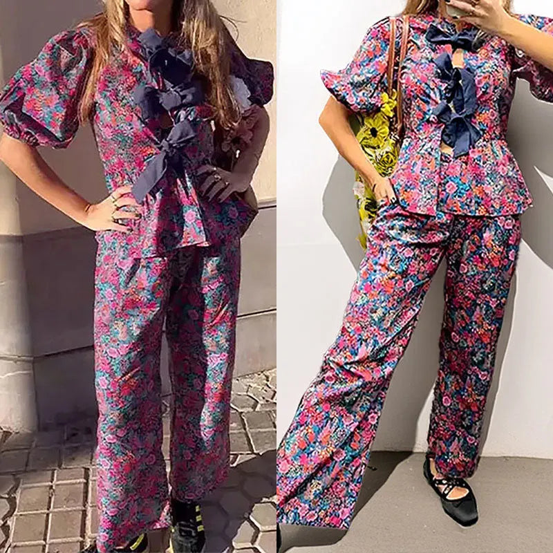 Floral print trousers suit with tie-neck blouse featuring puff sleeves and matching trousers