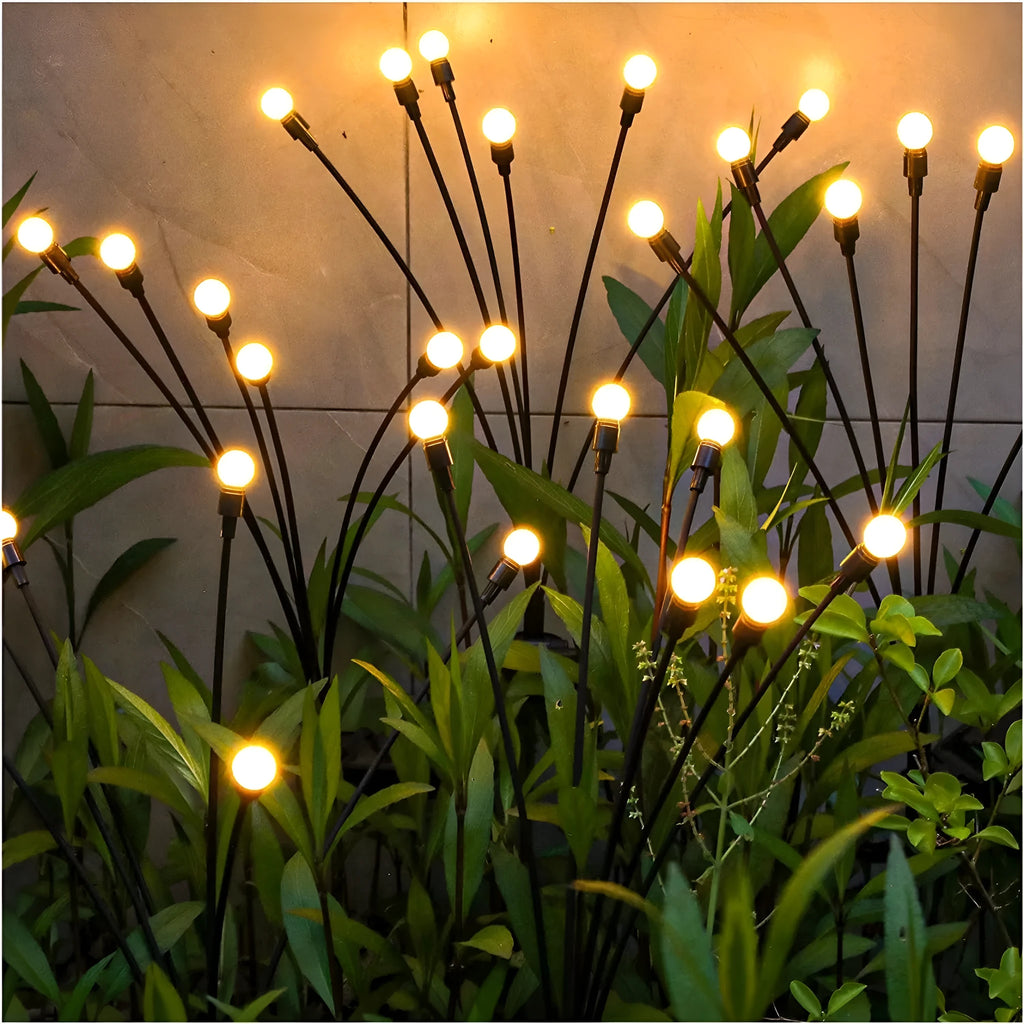 Solar-powered LED garden ground light with multiple light heads and a stainless steel spike for installation.