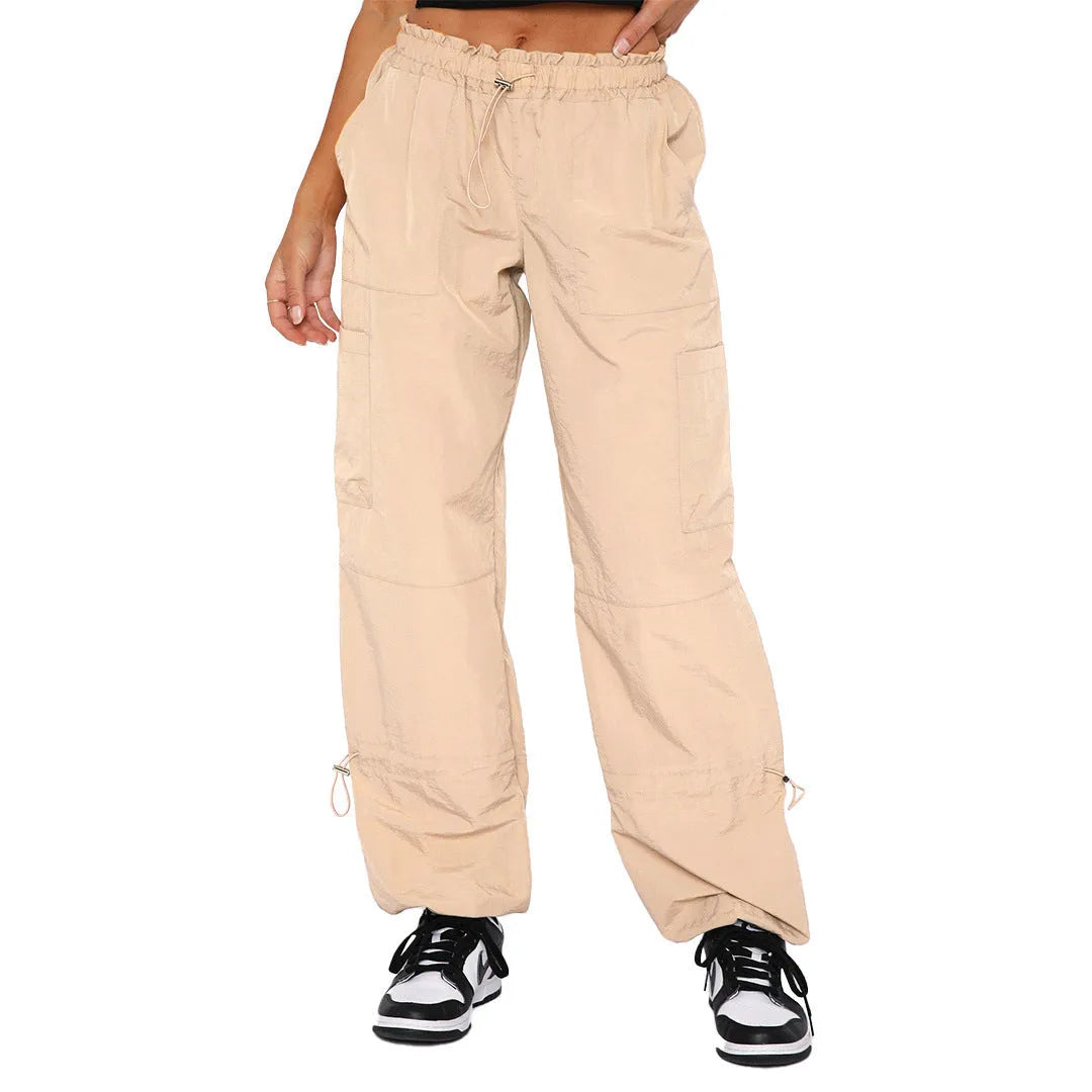 Man wearing loose grey straight-leg cargo casual pants with multiple pockets.