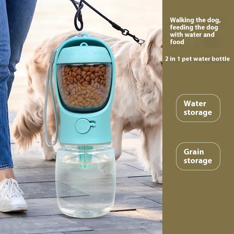 A blue portable plastic dog water bottle with an integrated flip-out drinking bowl on a green background.