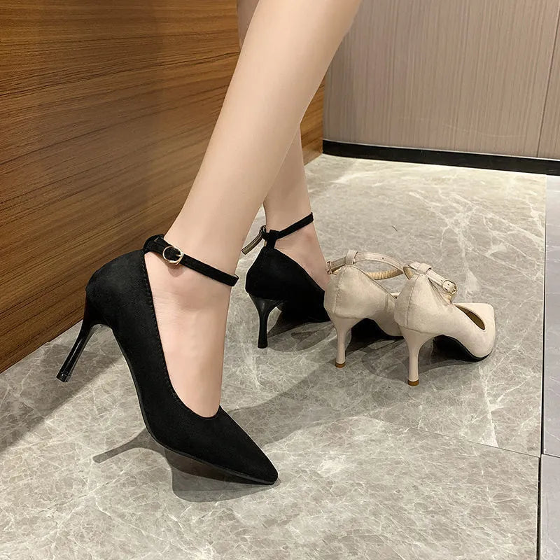 Women's black stiletto heel pumps with skull pattern and buckle closure