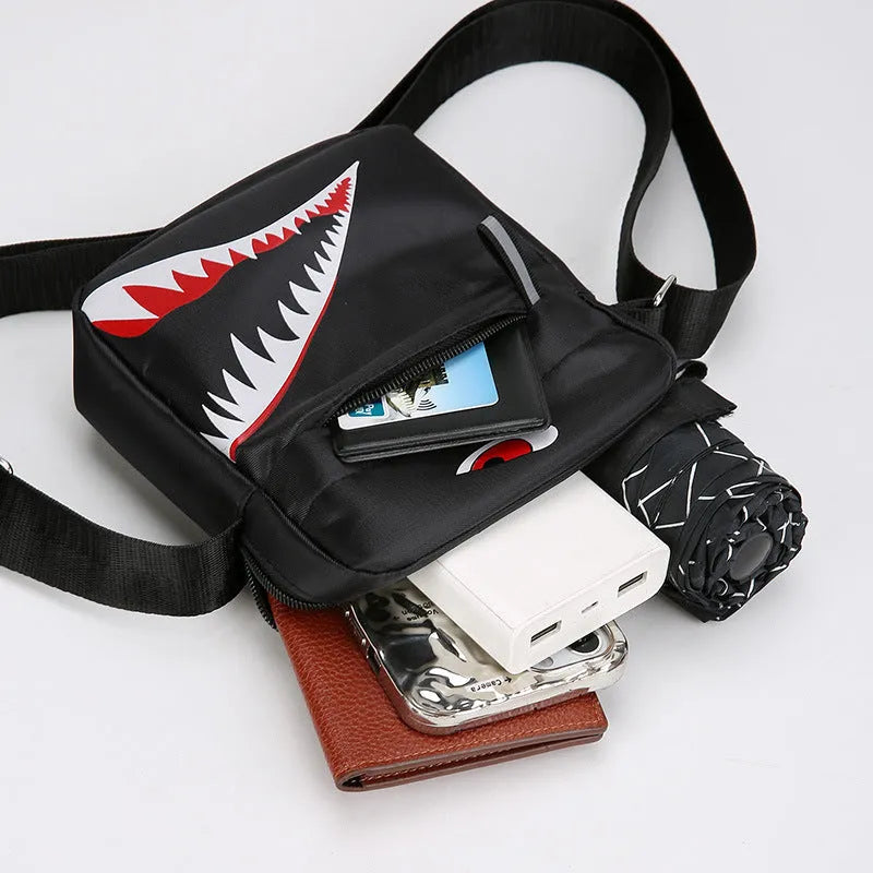 Men's small black Oxford cloth crossbody bag with animal print pattern and shoulder strap.