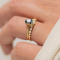Gold plated floral women's ring with green zircon stone inlay on model finger