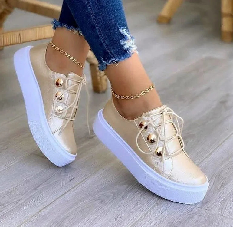 Women's white lace-up flats sneakers with metal rivet detailing and round toe design