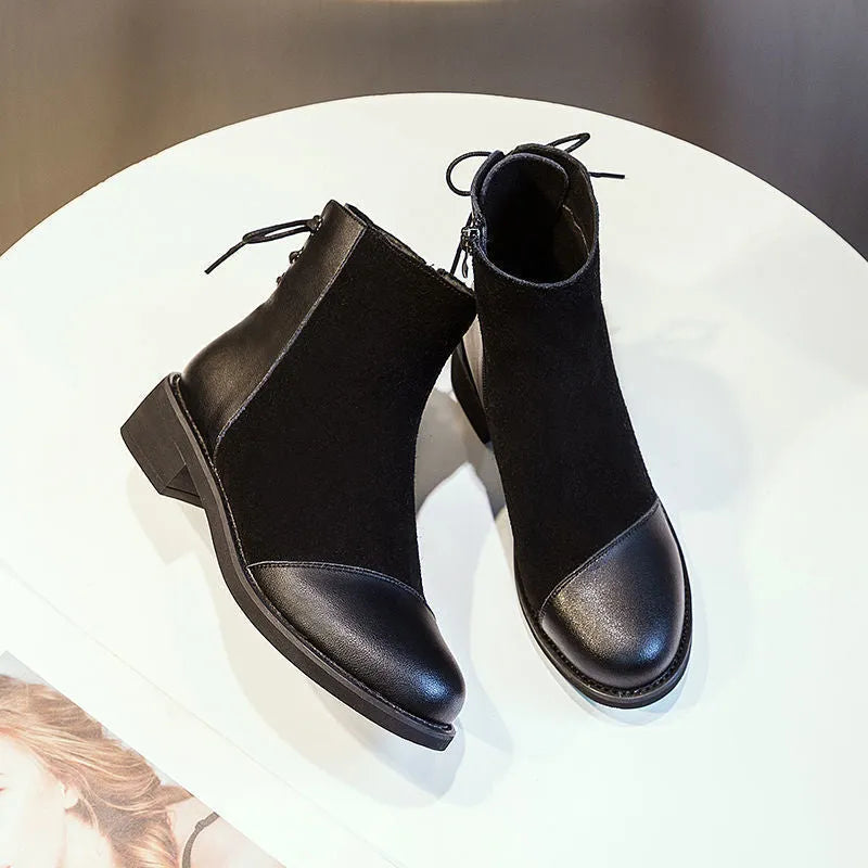 Black women's knee-high Martin boots with side zipper, round toe, and short stout heel.