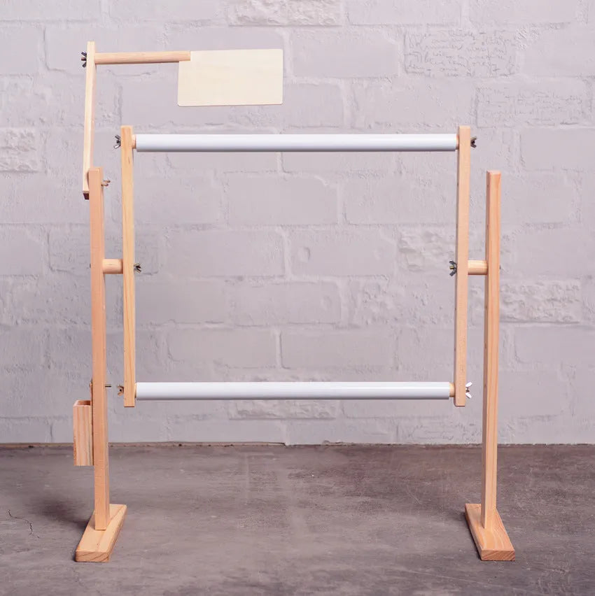 Solid pine wood vertical embroidery frame with height adjustment mechanism on a desktop