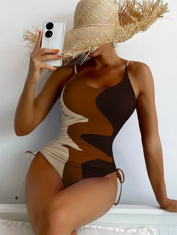 Blue women's sleeveless backless one-piece swimsuit with a striped print, made from polyester and nylon fabric.