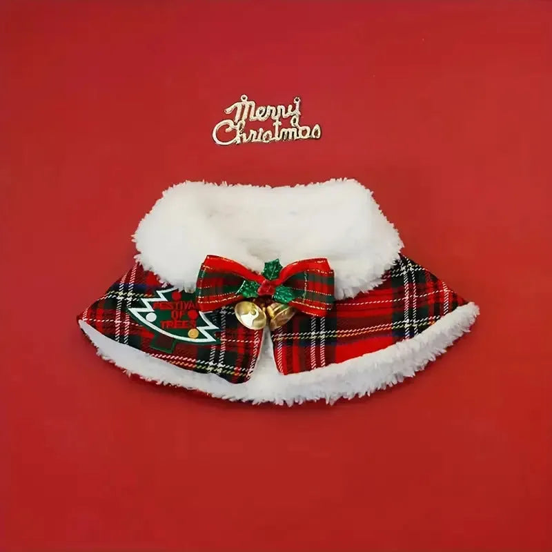 Pet wearing red Christmas cloak with bell design, draped over back with festive snowflake pattern