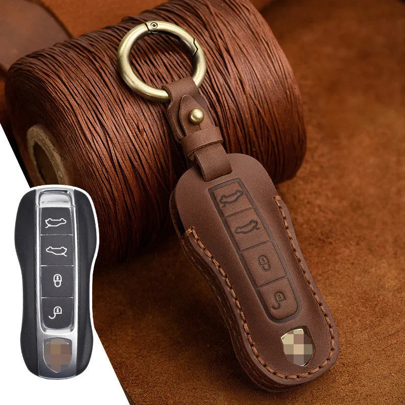 Brown leather Porsche key case with retro bag buckle holding three car keys